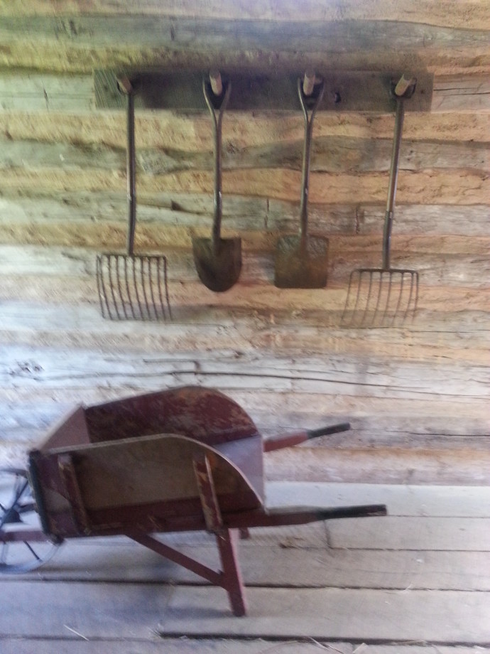 Wabi-Sabi Wonderland: rustic shovels, rakes and a wooden wheel barrow at Old World Wisconsin by Jenny Hoople